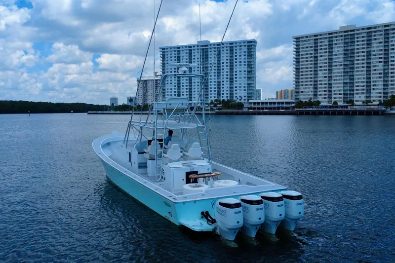 Highly Migratory Yacht Photos Pics 2017 Chesapeake 53 Center Console boat on water with city skyline background.