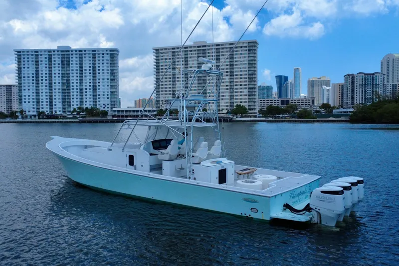Highly Migratory Yacht Photos Pics 2017 Chesapeake 53 Center Console boat on water with city skyline background.