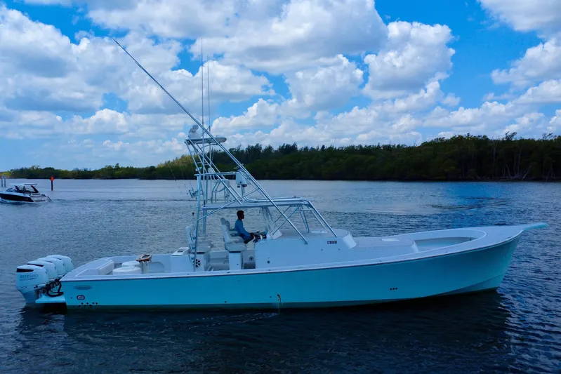 Highly Migratory Yacht Photos Pics 2017 Chesapeake 53 Center Console boat on calm water under a cloudy sky.