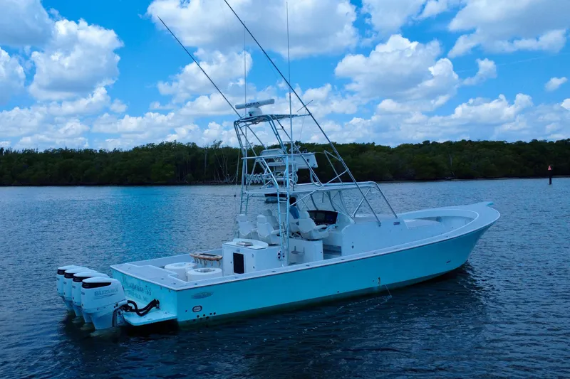 Highly Migratory Yacht Photos Pics 2017 Chesapeake 53 Center Console boat on calm water under a blue sky.