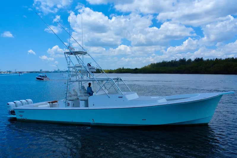 Highly Migratory Yacht Photos Pics 2017 Chesapeake 53 Center Console boat on calm water under a partly cloudy sky.