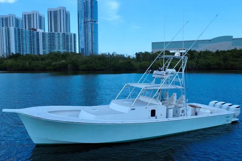 Highly Migratory Yacht Photos Pics 2017 Chesapeake 53 Center Console boat on water with city skyline background.