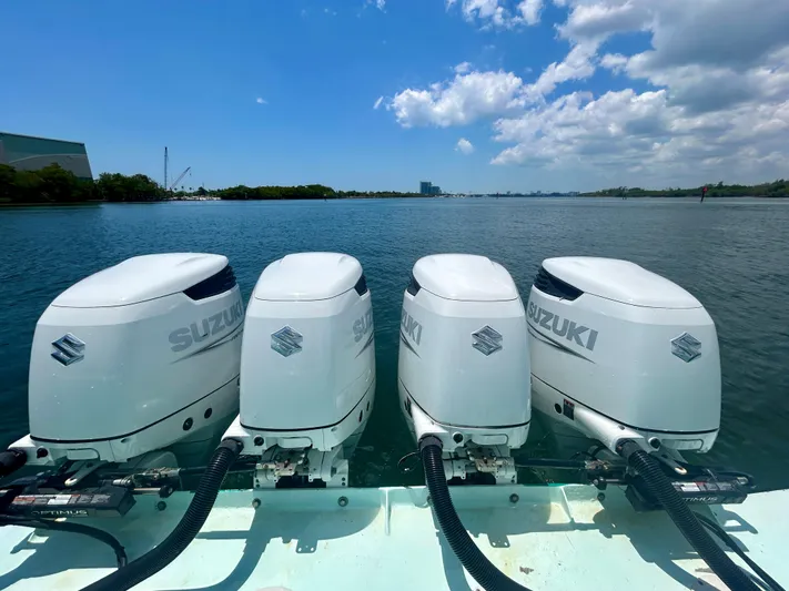 Highly Migratory Yacht Photos Pics Four Suzuki outboard motors on a 2017 Chesapeake 53 Center Console boat, on a sunny day.
