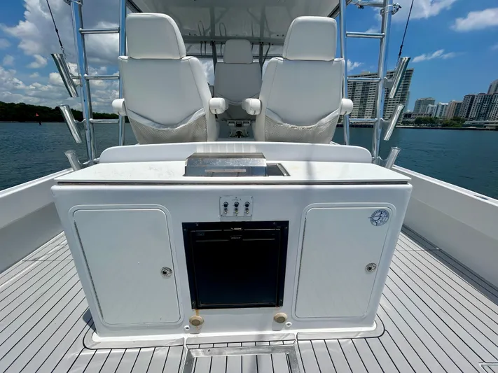 Highly Migratory Yacht Photos Pics 2017 Chesapeake 53 Center Console boat interior with seating and storage, docked near cityscape.