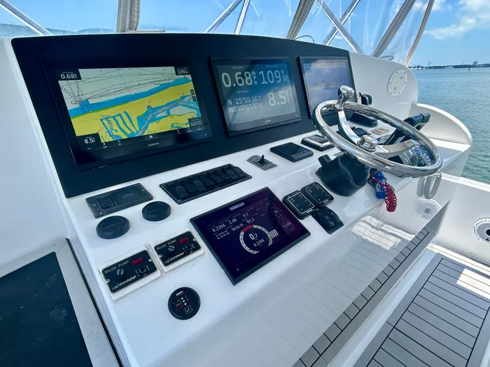 Highly Migratory Yacht Photos Pics 2017 Chesapeake 53 Center Console helm with navigation screens and steering wheel.