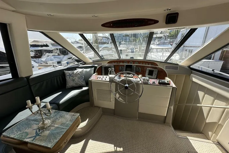  Yacht Photos Pics Luxurious 2000 Bayliner 5288 Pilot House Motoryacht interior with helm and seating area.