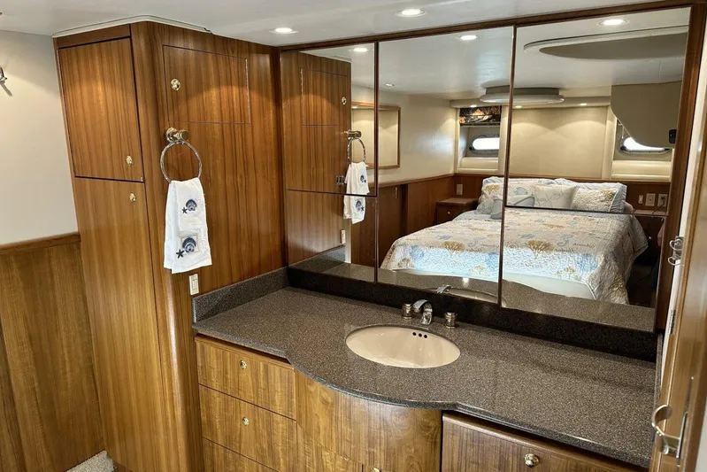  Yacht Photos Pics Luxurious 2000 Bayliner 5288 yacht interior with wood cabinetry and mirrored vanity.