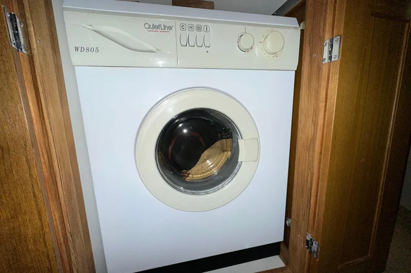  Yacht Photos Pics Compact washing machine in wooden cabinet on 2000 Bayliner 5288 Pilot House Motoryacht.