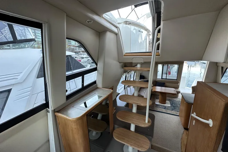  Yacht Photos Pics Interior of 2000 Bayliner 5288 Pilot House Motoryacht with wooden stairs and seating area.