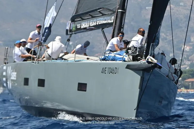 Manticore Yacht Photos Pics Sailing crew on 2019 Mylius 60 yacht during a race, navigating through blue waters.