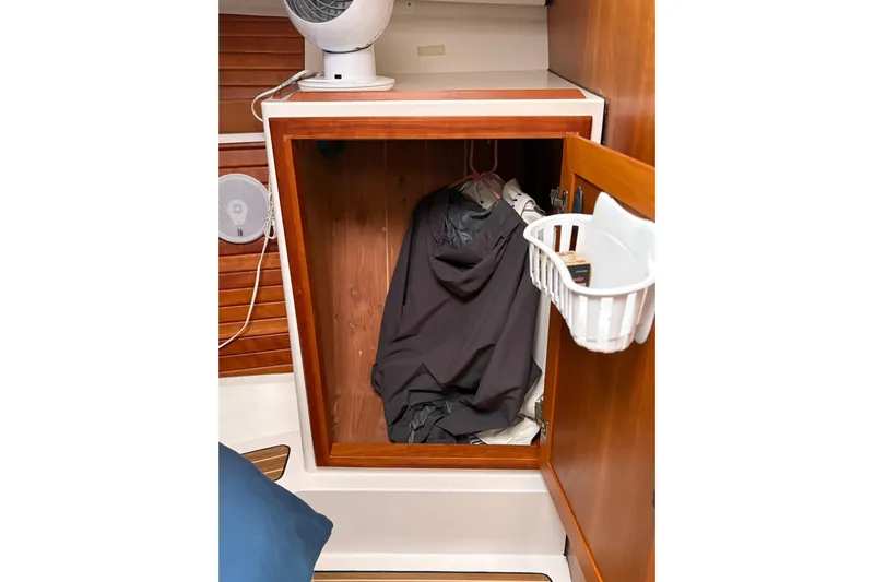  Yacht Photos Pics 2013 Back Cove 34 boat closet with hanging jackets and storage basket.