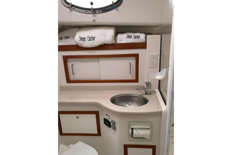 Yacht Photos Pics 2013 Back Cove 34 yacht bathroom with sink, storage cabinets, and "Dream Catcher" towels.