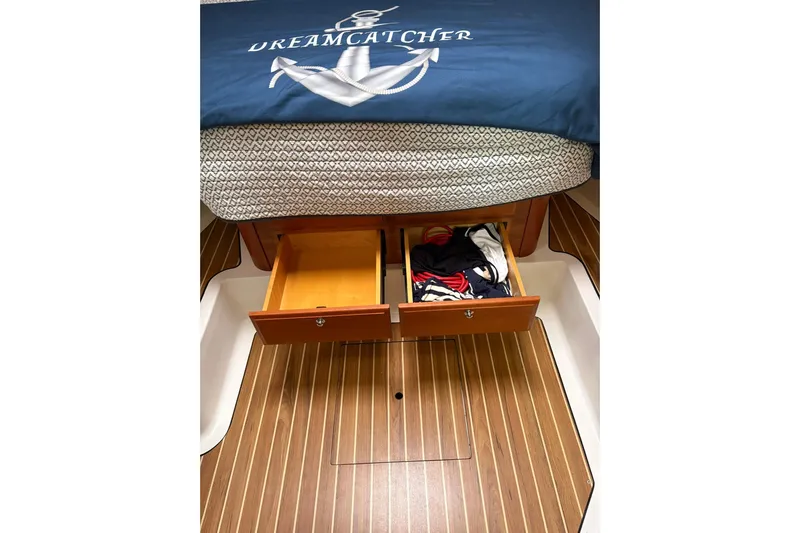 Yacht Photos Pics 2013 Back Cove 34 interior with open storage drawers under bed.