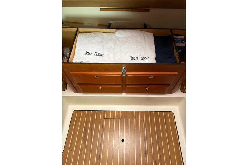  Yacht Photos Pics Interior of 2013 Back Cove 34 boat with wooden cabinetry and embroidered towels.