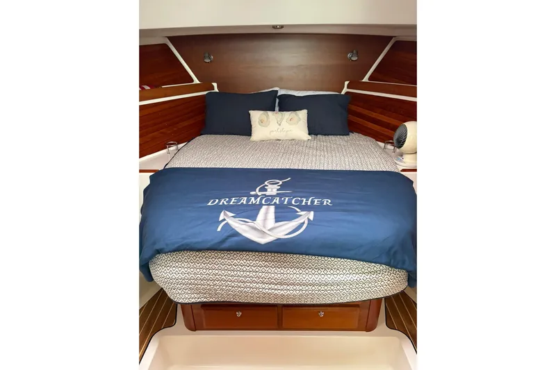  Yacht Photos Pics Cozy cabin bedroom in 2013 Back Cove 34 boat with nautical-themed bedding.