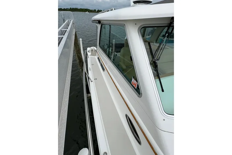  Yacht Photos Pics 2013 Back Cove 34 boat docked, showcasing sleek design and window details.