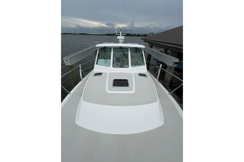  Yacht Photos Pics 2013 Back Cove 34 boat docked, showcasing sleek design and spacious deck.