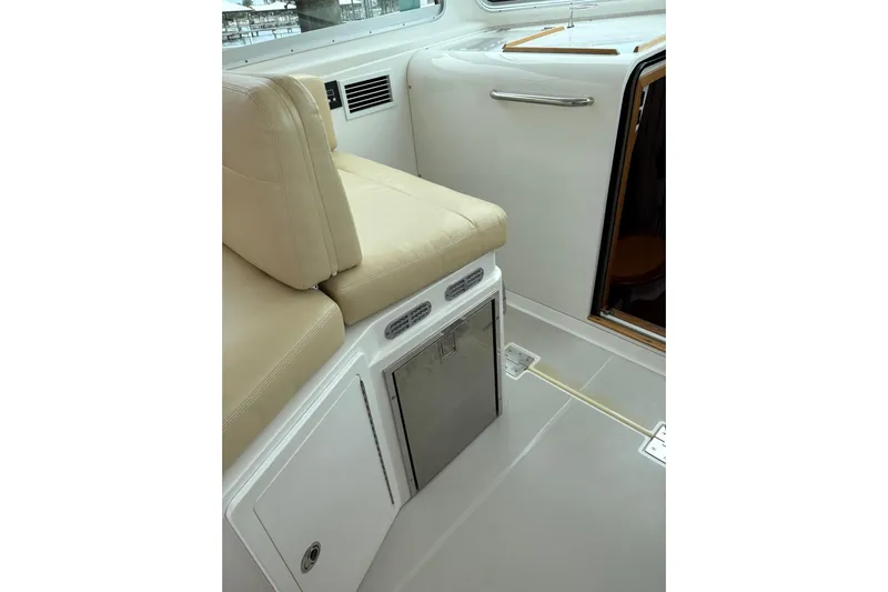  Yacht Photos Pics Interior of 2013 Back Cove 34 boat with beige seating and storage compartment.