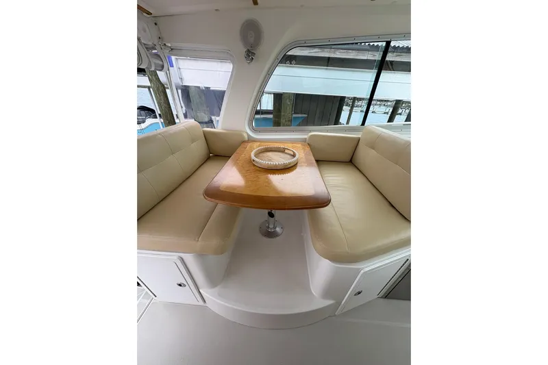  Yacht Photos Pics Interior of 2013 Back Cove 34 boat with beige seating and wooden table.