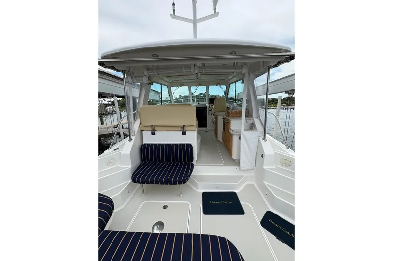  Yacht Photos Pics 2013 Back Cove 34 boat interior with striped seating and "Dream Catcher" mats.