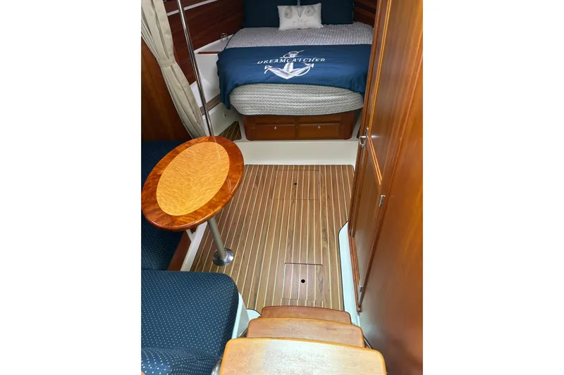  Yacht Photos Pics 2013 Back Cove 34 interior with wood flooring, cozy bed, and elegant table.