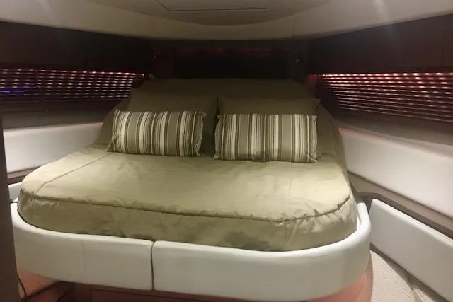  Yacht Photos Pics Interior cabin of 2014 Sea Ray 410 Sundancer with cozy bed and striped pillows.