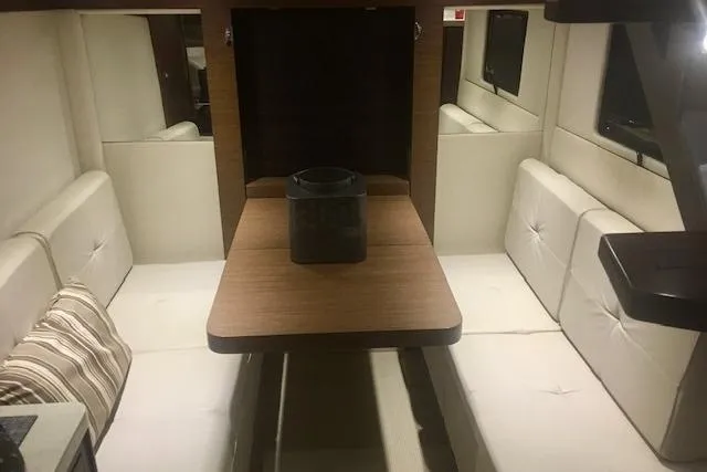  Yacht Photos Pics Interior of 2014 Sea Ray 410 Sundancer yacht with cozy seating and wooden table.