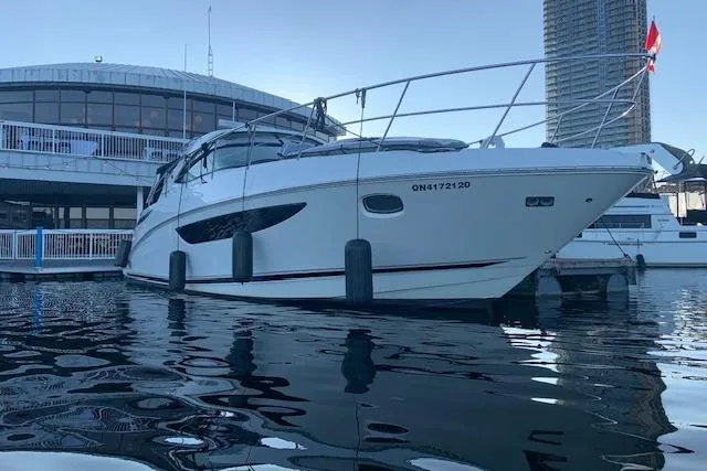  Yacht Photos Pics 2014 Sea Ray 410 Sundancer yacht docked at marina, reflecting on calm water.