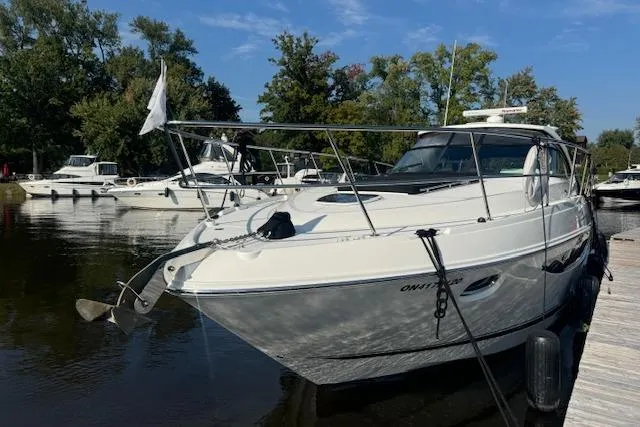  Yacht Photos Pics 2014 Sea Ray 410 Sundancer docked at marina, surrounded by trees and other boats.