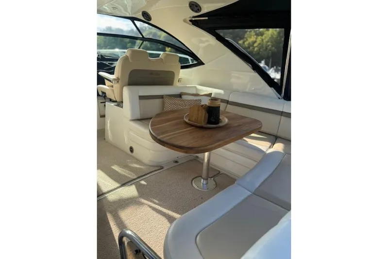  Yacht Photos Pics Luxurious interior of 2014 Sea Ray 410 Sundancer yacht with elegant seating and wooden table.