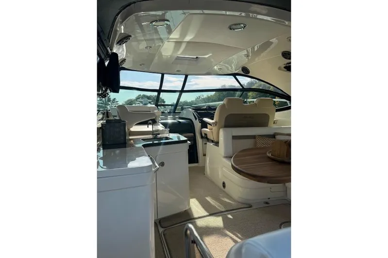  Yacht Photos Pics Interior of 2014 Sea Ray 410 Sundancer yacht with luxurious seating and helm.