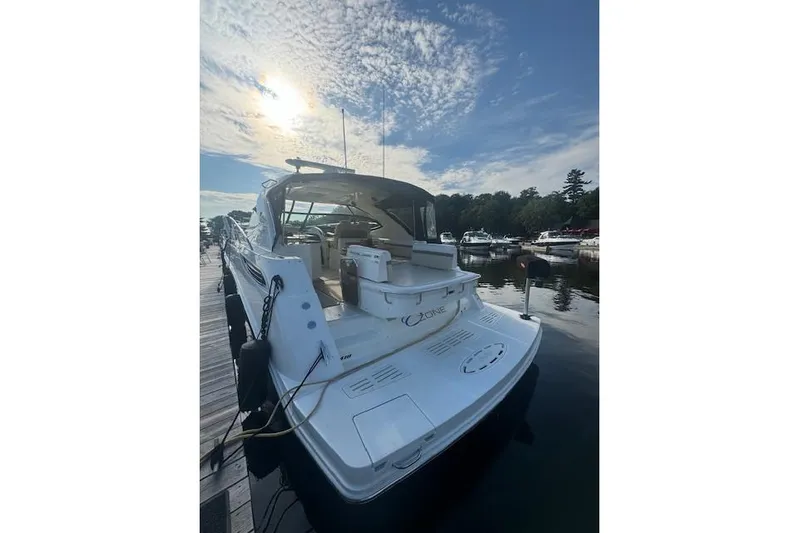  Yacht Photos Pics 2014 Sea Ray 410 Sundancer yacht docked under a partly cloudy sky.