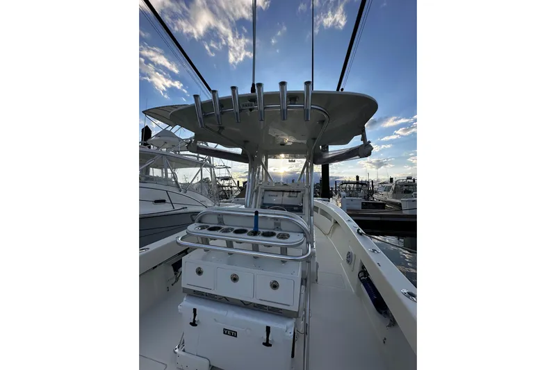 Engel-sea Yacht Photos Pics 2014 SeaVee 290B boat interior with fishing rod holders at marina, under a blue sky.