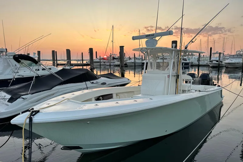 Engel-sea Yacht Photos Pics 2014 SeaVee 290B boat docked at sunset, surrounded by other vessels.