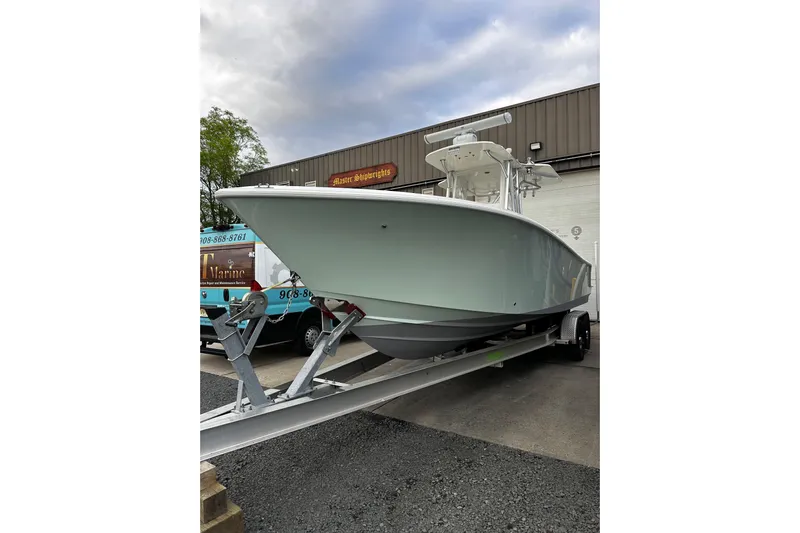 Engel-sea Yacht Photos Pics 2014 SeaVee 290B boat on trailer, parked outside a marine service facility.