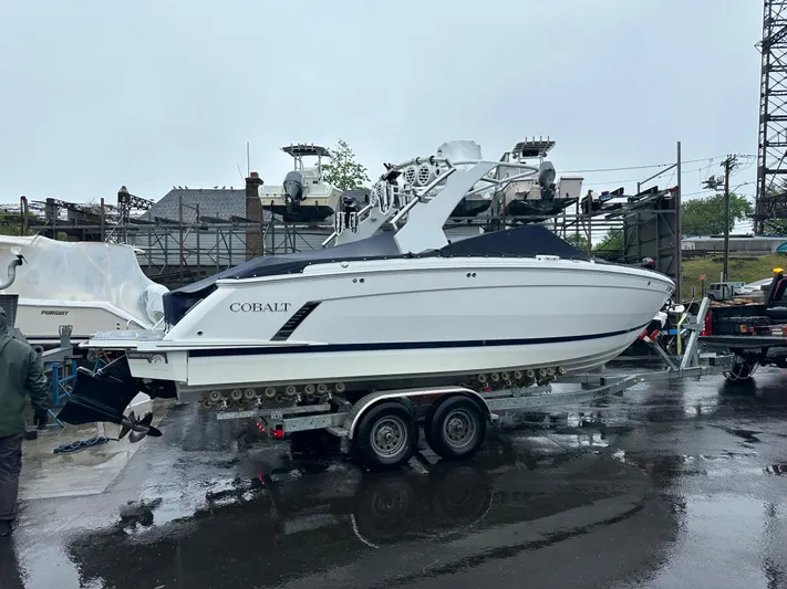  Yacht Photos Pics 2022 Cobalt R8 Surf boat on trailer in a wet marina setting.