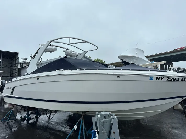  Yacht Photos Pics 2022 Cobalt R8 Surf boat on display, white exterior, parked on a wet surface.