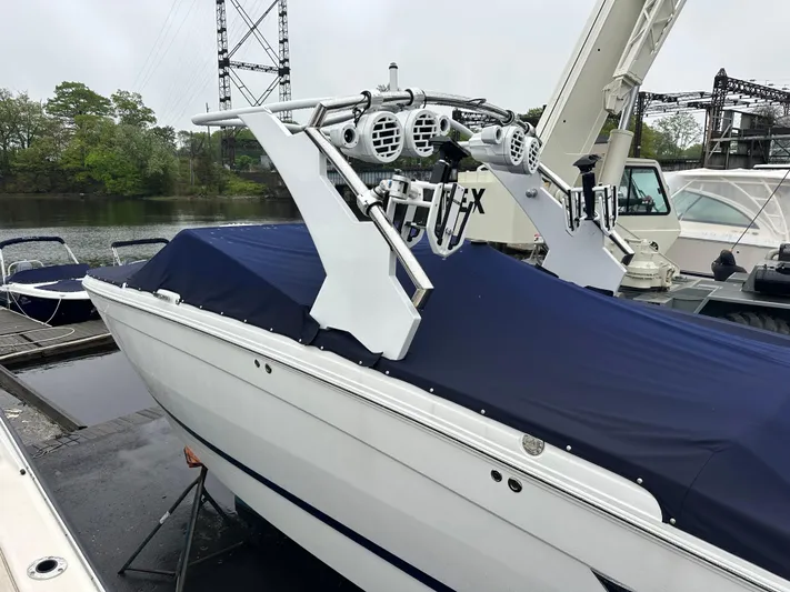  Yacht Photos Pics 2022 Cobalt R8 Surf boat with blue cover docked near water.