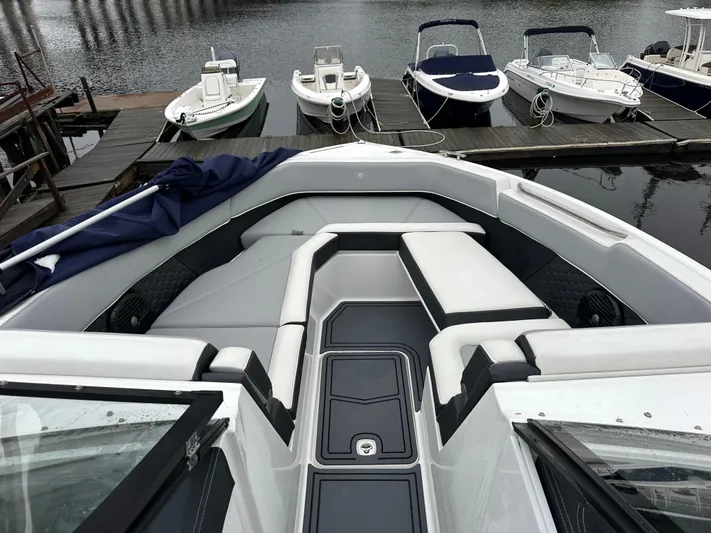  Yacht Photos Pics 2022 Cobalt R8 Surf boat with sleek seating at a marina dock.