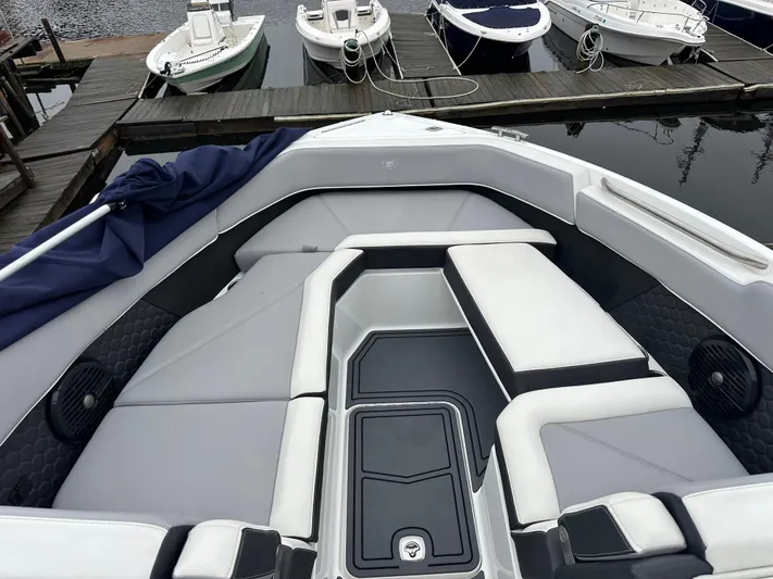  Yacht Photos Pics 2022 Cobalt R8 Surf boat interior with sleek seating at a dock.