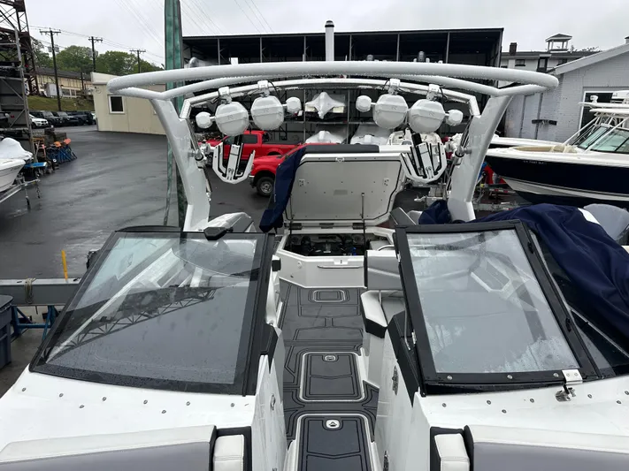  Yacht Photos Pics 2022 Cobalt R8 Surf boat with open deck and modern design, docked in a marina.