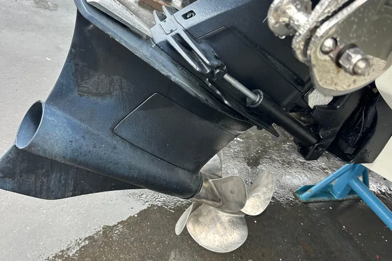  Yacht Photos Pics 2022 Cobalt R8 Surf boat propeller and outdrive close-up on a wet surface.