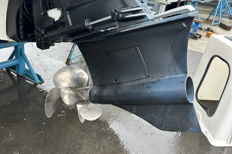  Yacht Photos Pics Propeller of 2022 Cobalt R8 Surf boat on a wet surface.