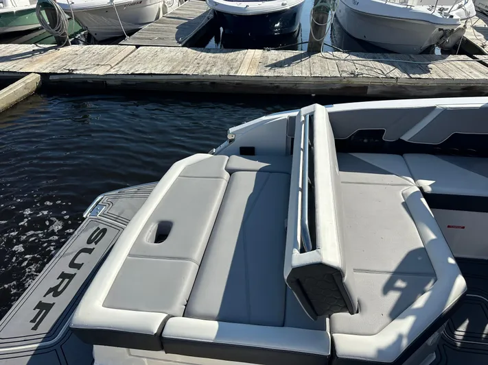  Yacht Photos Pics 2022 Cobalt R8 Surf boat with gray seating at a marina dock.