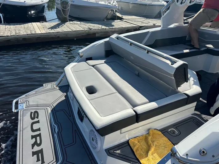  Yacht Photos Pics 2022 Cobalt R8 Surf boat with gray seating, docked at marina.