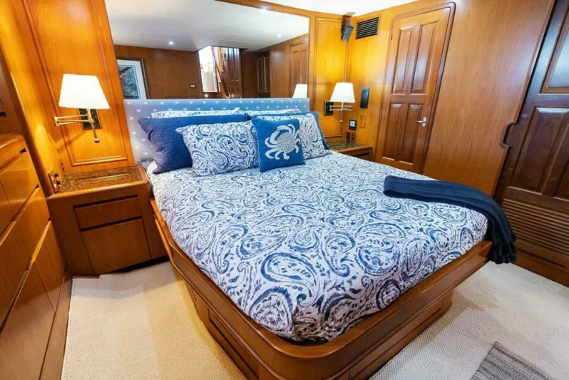 Orion II Yacht Photos Pics Luxurious bedroom in 2001 Grand Alaskan 64 Pilot House yacht with elegant wood paneling.