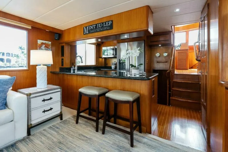 Orion II Yacht Photos Pics Luxurious interior of 2001 Grand Alaskan 64 Pilot House yacht with elegant wood finishes.