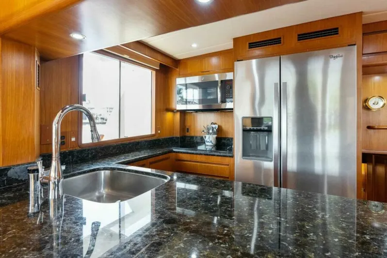 Orion II Yacht Photos Pics Luxurious kitchen in 2001 Grand Alaskan 64 Pilot House yacht with modern appliances and sleek design.