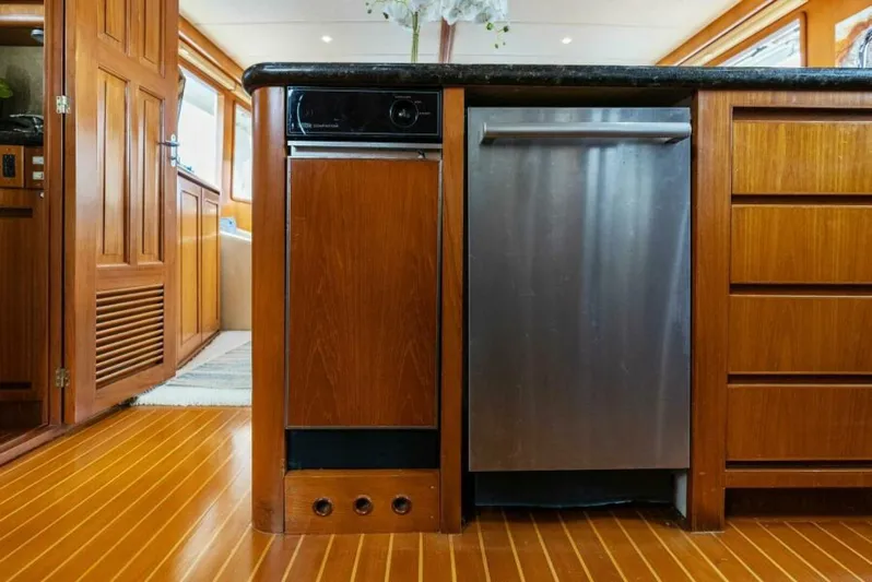 Orion II Yacht Photos Pics Interior of 2001 Grand Alaskan 64 Pilot House with wood cabinetry and stainless steel appliances.