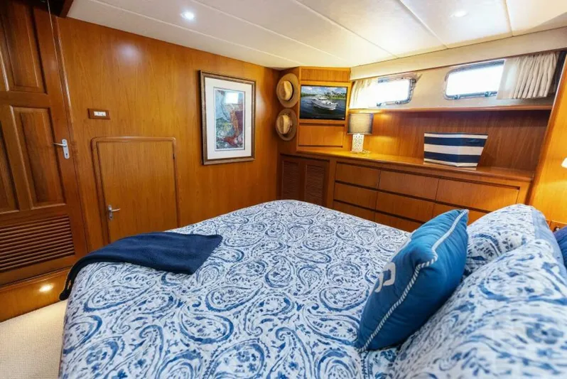 Orion II Yacht Photos Pics Luxurious bedroom interior of 2001 Grand Alaskan 64 Pilot House yacht with elegant wood finish.
